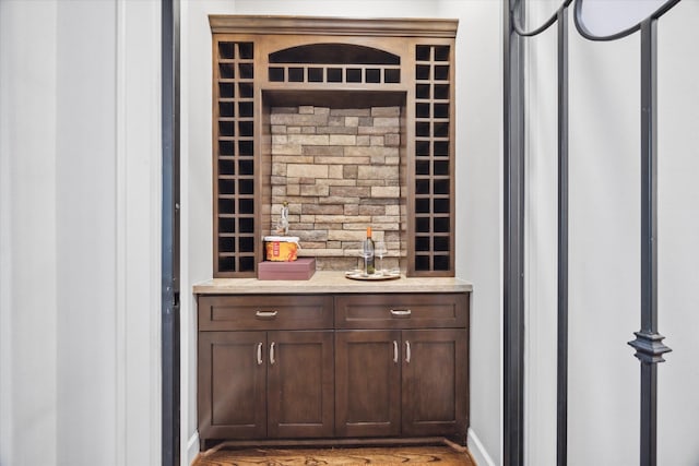 wine room featuring bar area and hardwood / wood-style flooring