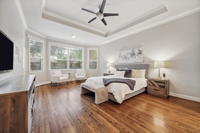 bedroom with dark wood-type flooring, ceiling fan, a raised ceiling, and crown molding