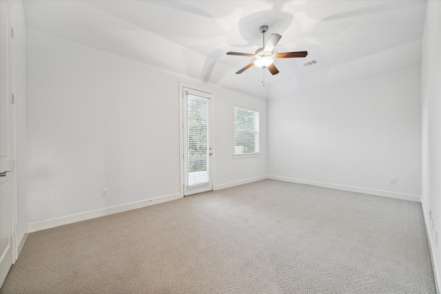 spare room featuring light colored carpet and ceiling fan