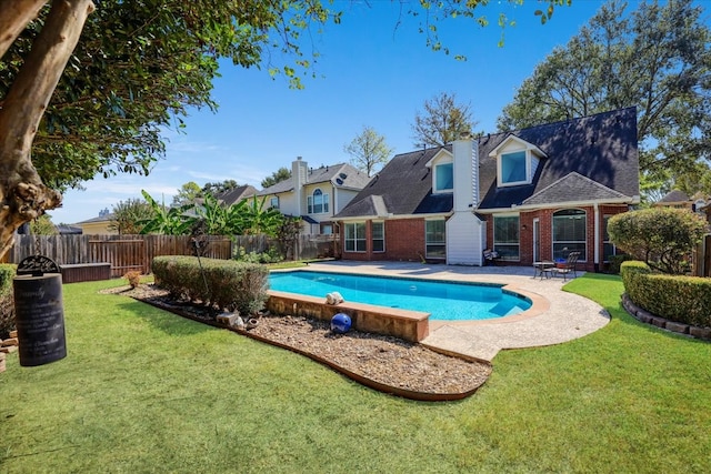 view of pool featuring a yard and a patio area