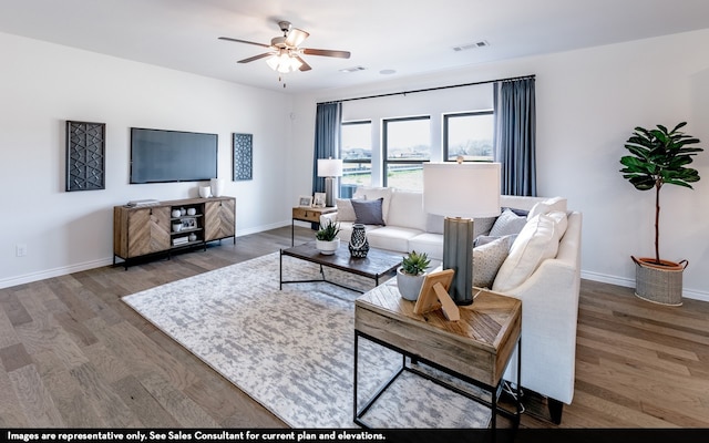 living room featuring ceiling fan and hardwood / wood-style flooring