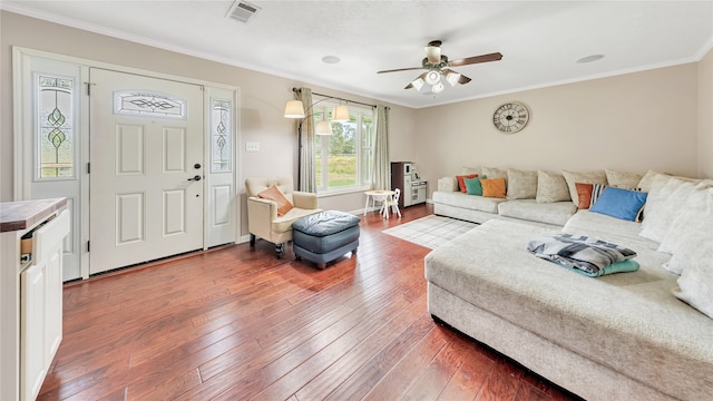 living room with ceiling fan, wood-type flooring, and crown molding