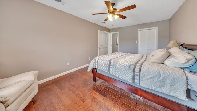 bedroom with hardwood / wood-style flooring, ceiling fan, and a closet