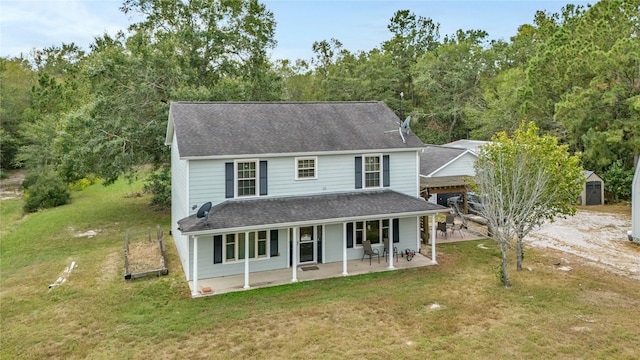 view of front of property featuring a shed, a patio, and a front yard