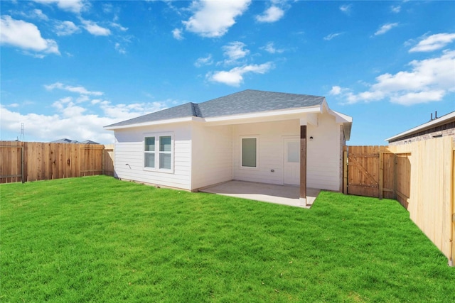 back of house featuring a yard and a patio