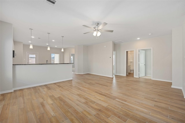 unfurnished living room with ceiling fan and light wood-type flooring