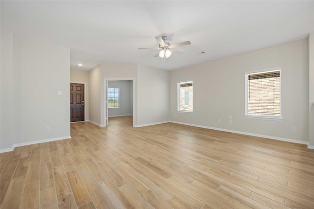 spare room featuring ceiling fan, plenty of natural light, and light hardwood / wood-style flooring