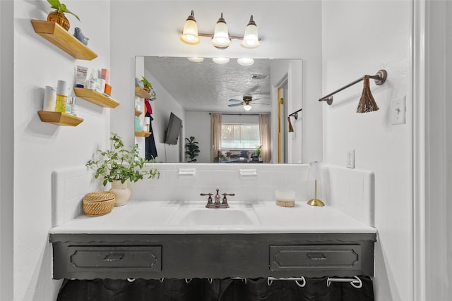 bathroom featuring vanity, a textured ceiling, and ceiling fan