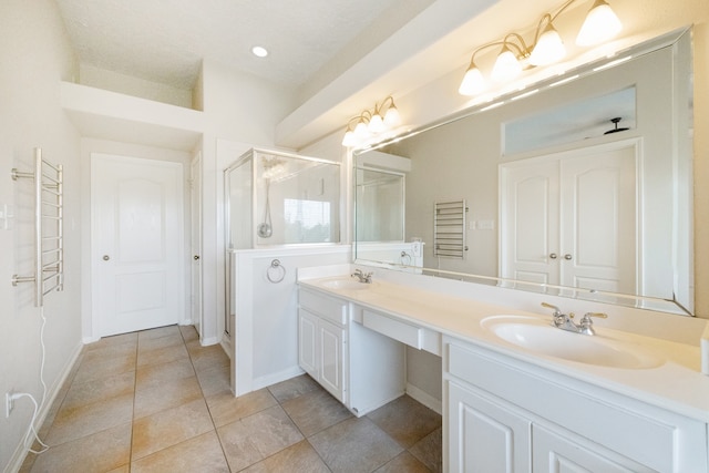 bathroom featuring walk in shower, tile patterned flooring, and vanity