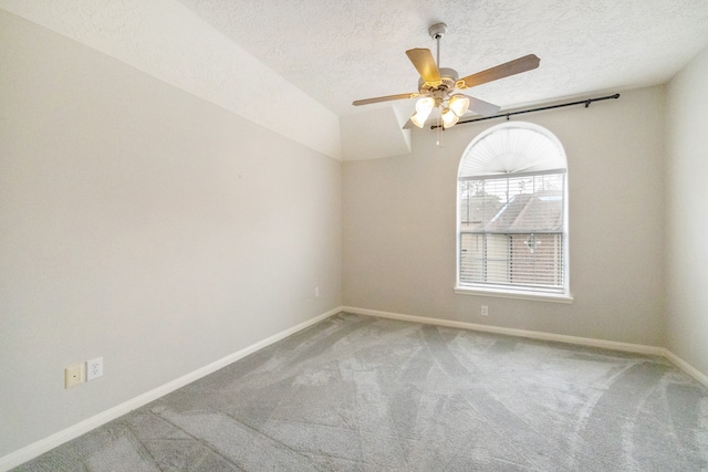 carpeted spare room featuring ceiling fan and a textured ceiling