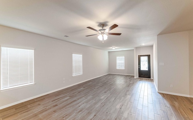 interior space with light hardwood / wood-style flooring and ceiling fan