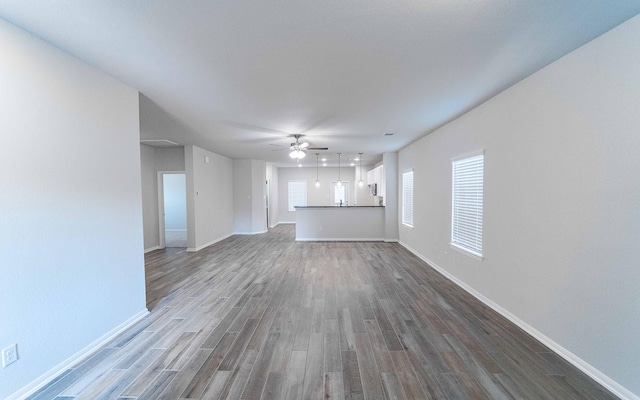 unfurnished living room featuring hardwood / wood-style floors and ceiling fan