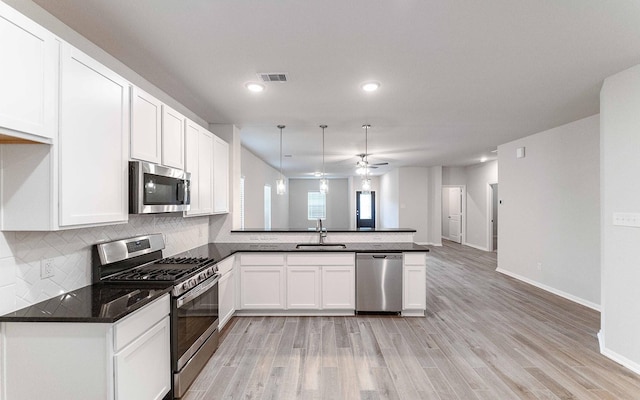 kitchen featuring white cabinetry, ceiling fan, light wood-type flooring, and appliances with stainless steel finishes