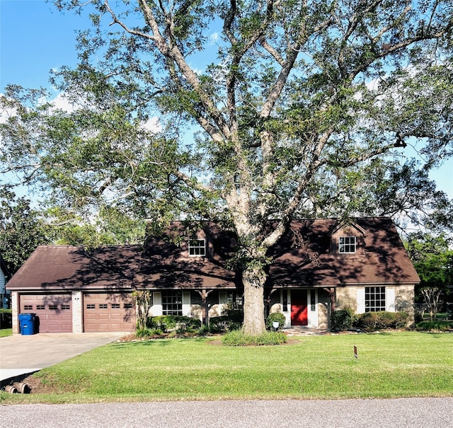 view of front of house with a front yard and a garage