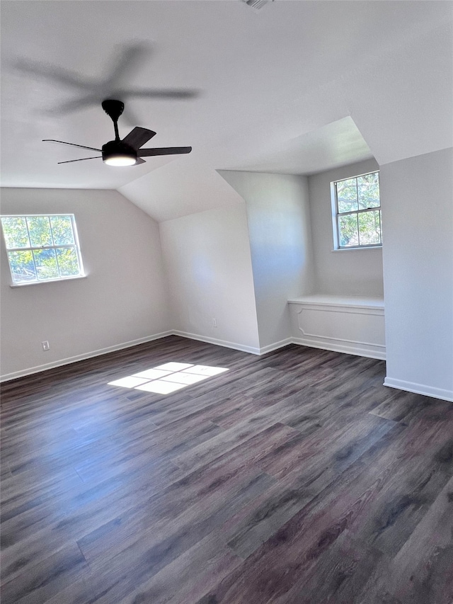 bonus room with vaulted ceiling, dark wood-type flooring, plenty of natural light, and ceiling fan