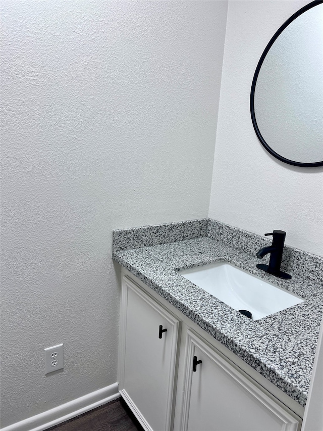 bathroom with vanity and hardwood / wood-style flooring