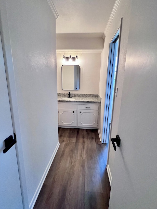 bathroom with vanity, hardwood / wood-style floors, and ornamental molding