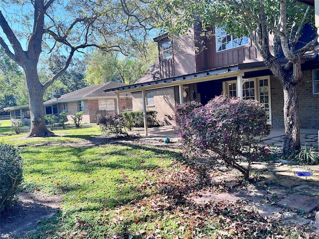 rear view of property with a lawn