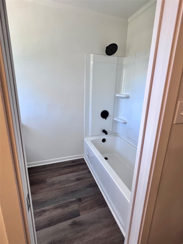 bathroom with crown molding, wood-type flooring, and shower / bathtub combination