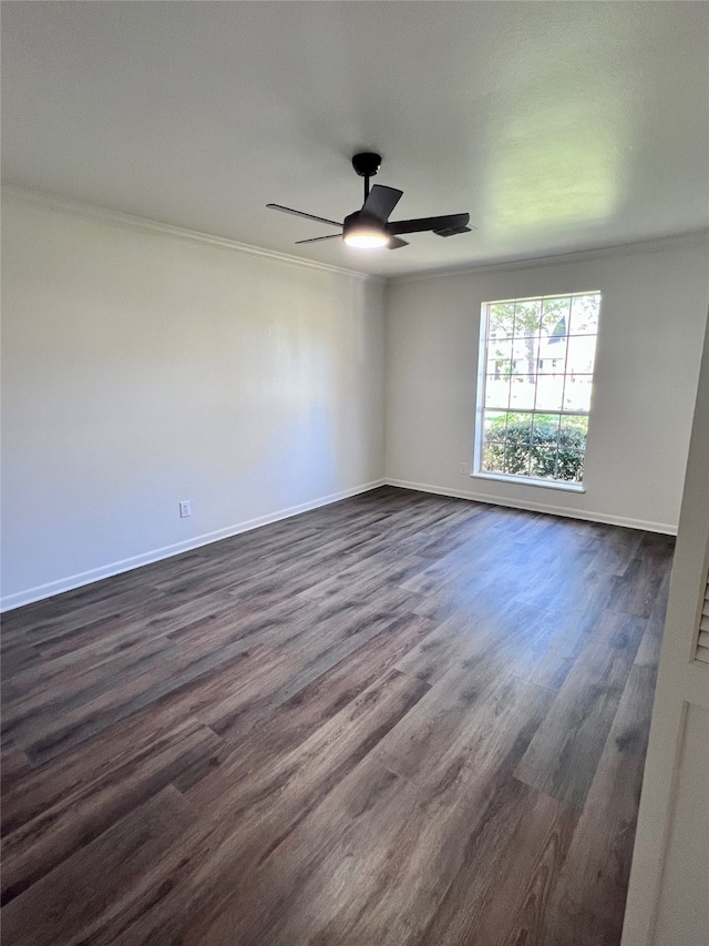 empty room with ceiling fan, crown molding, and dark hardwood / wood-style floors