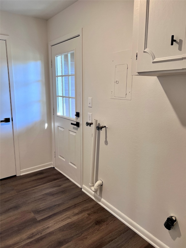 doorway with dark hardwood / wood-style floors and electric panel