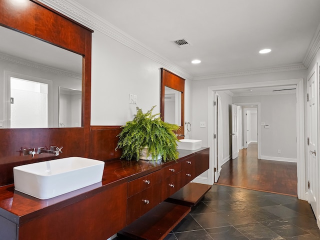 bathroom with vanity, crown molding, and wood-type flooring