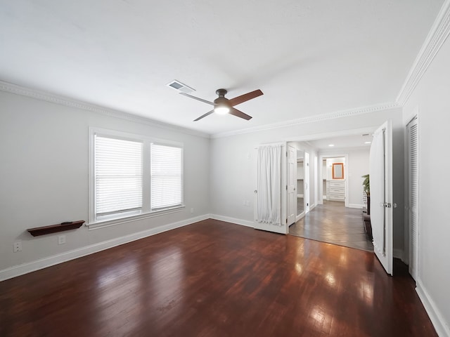 empty room featuring ornamental molding, ceiling fan, and dark hardwood / wood-style flooring