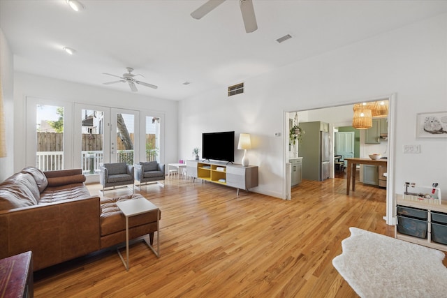 living room with light wood-type flooring and ceiling fan