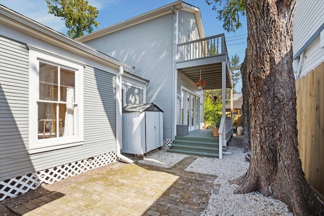 back of property featuring a patio and a balcony