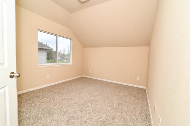 bonus room with carpet and vaulted ceiling