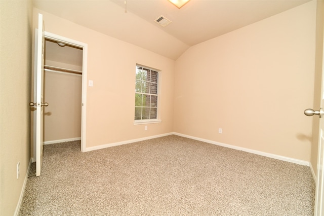 unfurnished bedroom with lofted ceiling and carpet floors