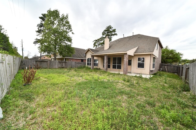 back of property featuring a lawn