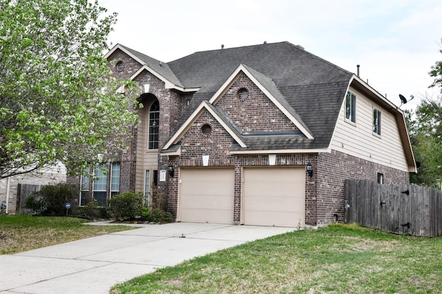 view of front of house featuring a front lawn and a garage