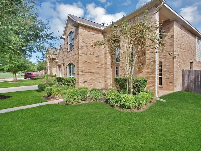 view of side of property with a yard