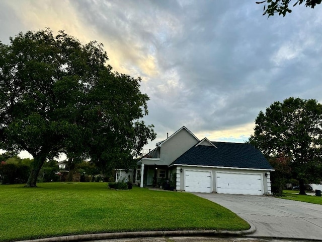 view of front of home with a yard and a garage