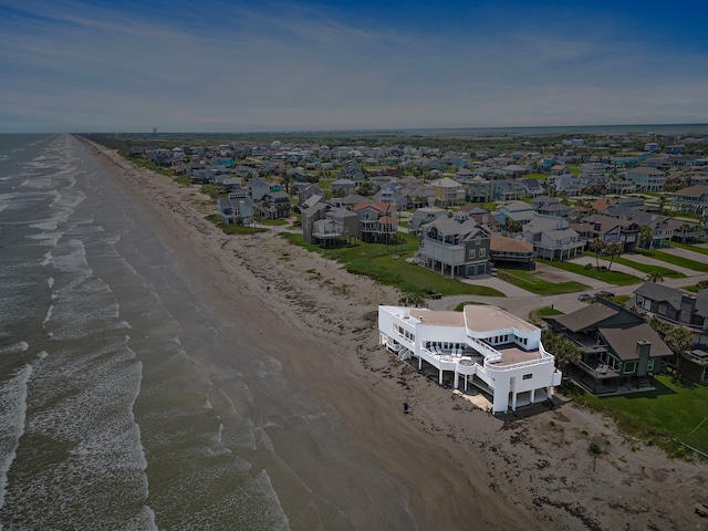 birds eye view of property with a water view and a view of the beach