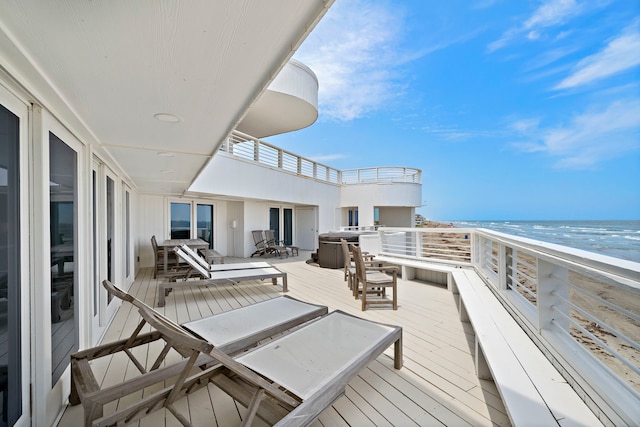 exterior space featuring a beach view and a water view