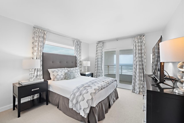 bedroom featuring light carpet and access to outside