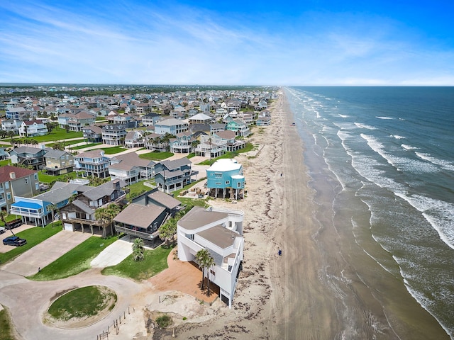 birds eye view of property with a beach view and a water view