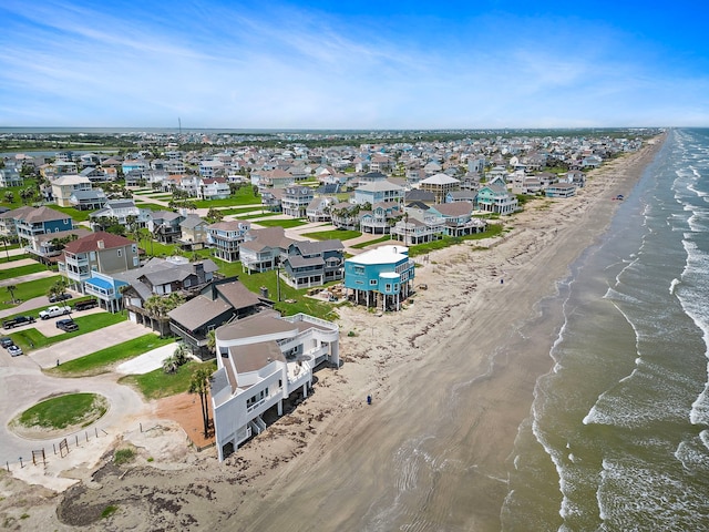 drone / aerial view featuring a water view and a view of the beach