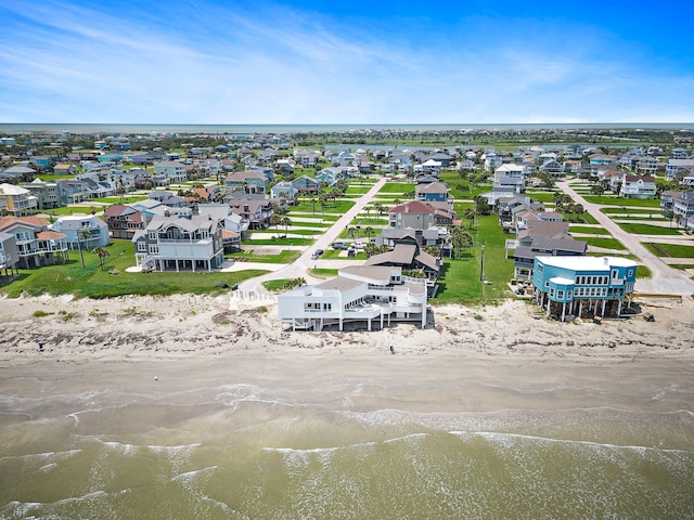 aerial view with a water view and a view of the beach