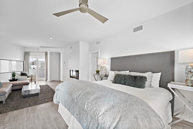 bedroom with ceiling fan and light wood-type flooring