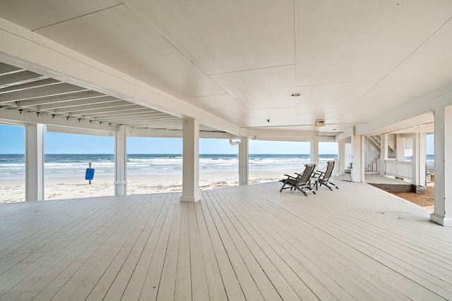 wooden terrace with a water view and a beach view