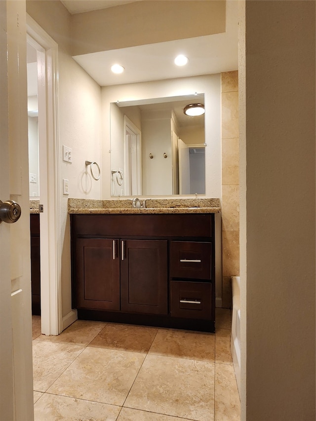 bathroom with vanity and tile walls