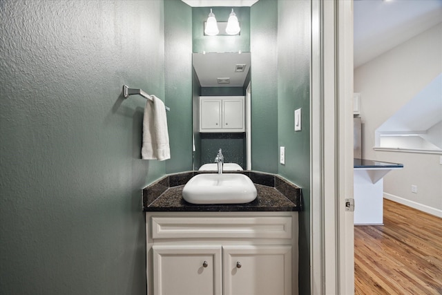 bathroom with vanity and wood-type flooring