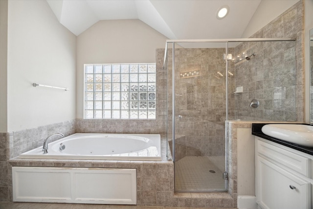 bathroom with vanity, vaulted ceiling, and plus walk in shower