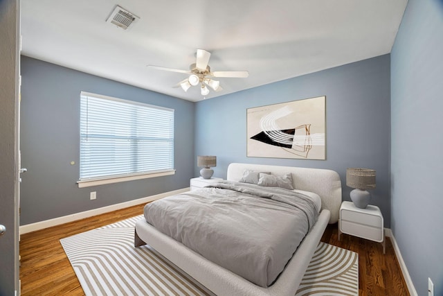 bedroom featuring dark hardwood / wood-style floors and ceiling fan