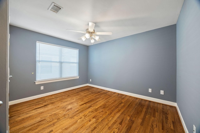 empty room with hardwood / wood-style flooring and ceiling fan