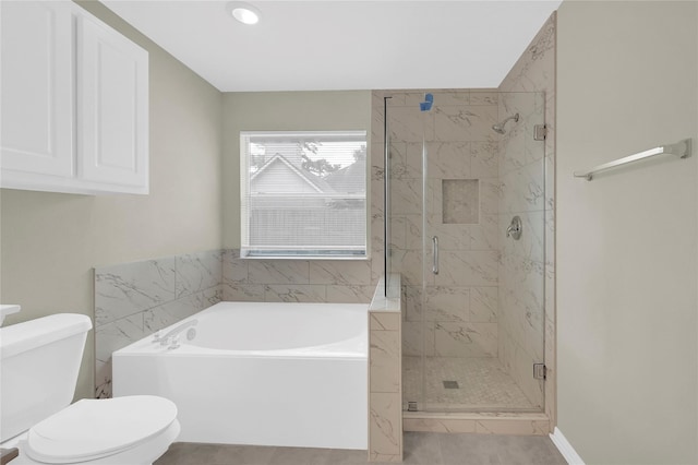 bathroom featuring tile patterned flooring, toilet, and separate shower and tub