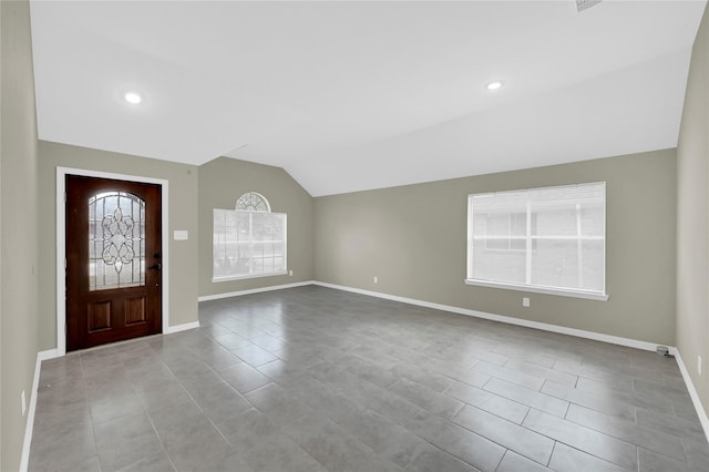 foyer featuring lofted ceiling and light tile patterned flooring